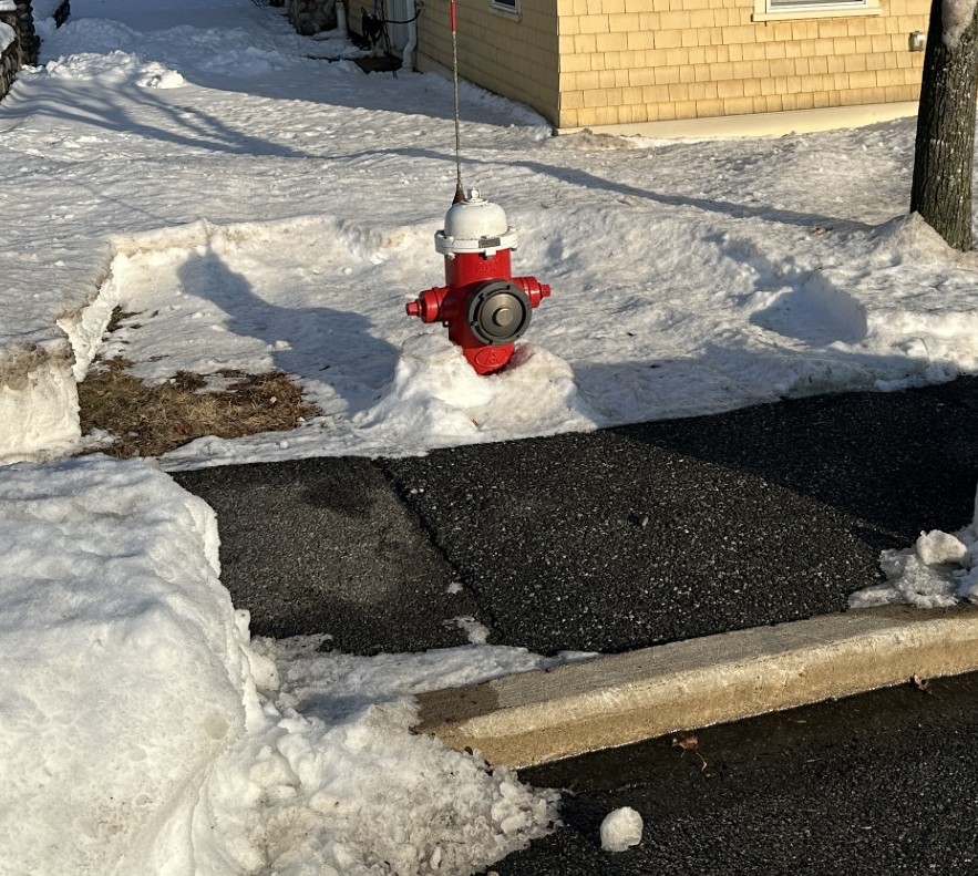 A photograph of a fire hydrant with the snow removed around it in a radius.